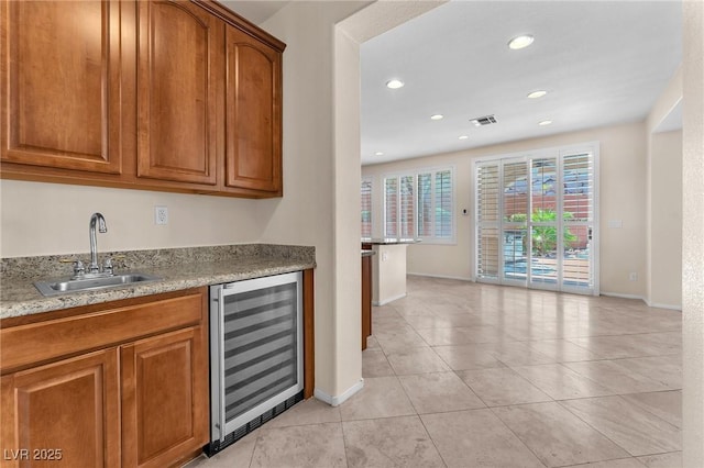 1155 Phillip Island St, Henderson, NV 89052 - indoor wet bar with wine cooler, light tile patterned floors, and recessed lighting