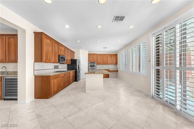 1155 Phillip Island St, Henderson, NV 89052 - kitchen featuring stainless steel appliances, light stone counters, backsplash, light tile patterned flooring, and recessed lighting