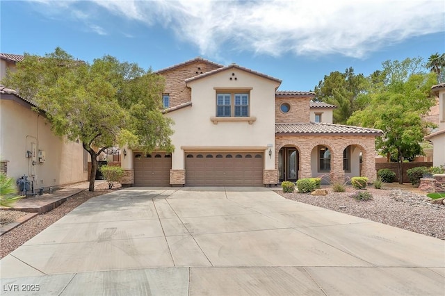 1155 Phillip Island St, Henderson, NV 89052 - mediterranean / spanish home featuring a tiled roof, stone siding, driveway, and stucco siding