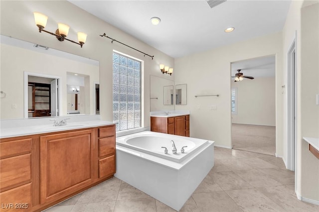 1155 Phillip Island St, Henderson, NV 89052 - full bathroom featuring a ceiling fan, two vanities, a bath, and tile patterned floors