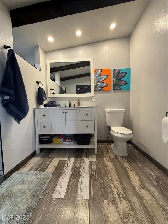 250 E Madison Ave, Ely, NV 89301 - bathroom featuring wood finished floors, toilet, vanity, baseboards, and recessed lighting
