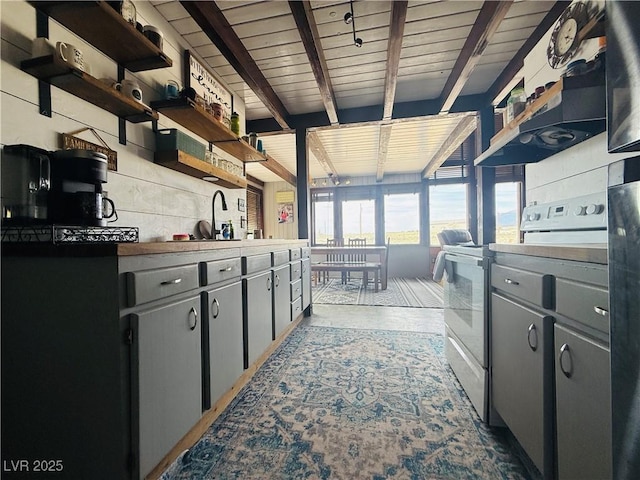 250 E Madison Ave, Ely, NV 89301 - kitchen with open shelves, electric range, wood ceiling with exposed beams, and a sink