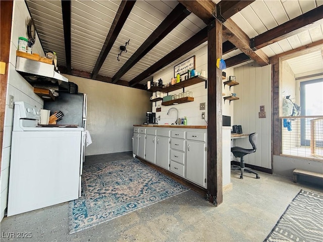 250 E Madison Ave, Ely, NV 89301 - kitchen featuring open shelves, washer / clothes dryer, beam ceiling, a desk, and a sink