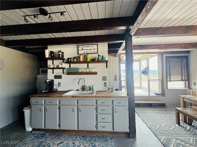 250 E Madison Ave, Ely, NV 89301 - kitchen with a sink, wooden ceiling with exposed beams, open shelves, wooden counters, and gray cabinetry