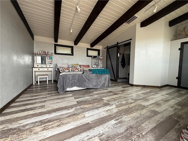 250 E Madison Ave, Ely, NV 89301 - living room featuring a barn door, wood finished floors, wooden ceiling with exposed beams, and baseboards