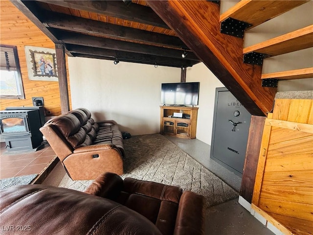 250 E Madison Ave, Ely, NV 89301 - living area featuring a wood stove, wooden walls, and beam ceiling