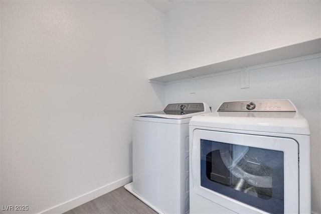 9265 Frazer St, Las Vegas, NV 89166 - laundry area with washer and dryer, wood finished floors, and baseboards