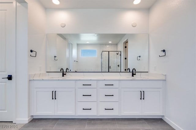 9265 Frazer St, Las Vegas, NV 89166 - bathroom featuring double vanity, a stall shower, and baseboards
