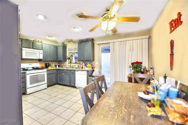 4145 Plumtree St, Las Vegas, NV 89115 - kitchen featuring white appliances, light tile patterned floors, a ceiling fan, light countertops, and gray cabinetry
