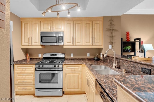 270 E Flamingo Rd Unit 131, Las Vegas, NV 89169 - kitchen with stainless steel appliances, a sink, light brown cabinetry, and light tile patterned floors