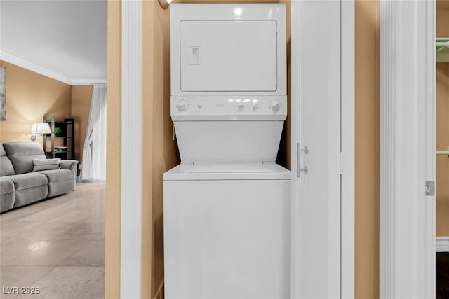 270 E Flamingo Rd Unit 131, Las Vegas, NV 89169 - washroom with stacked washer and clothes dryer and ornamental molding