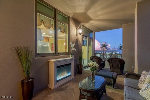 1 Hughes Center Dr Unit 308, Las Vegas, NV 89169 - living area with a glass covered fireplace and a wall of windows