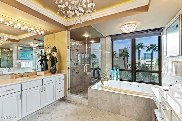 1 Hughes Center Dr Unit 308, Las Vegas, NV 89169 - bathroom featuring a chandelier, a raised ceiling, ornamental molding, vanity, and a garden tub