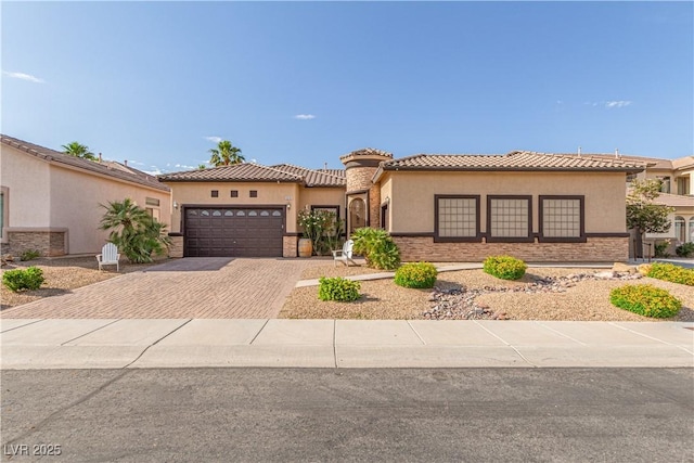 5576 Buena Martina Way, Las Vegas, NV 89141 - mediterranean / spanish-style house with decorative driveway, a garage, stucco siding, and a tile roof