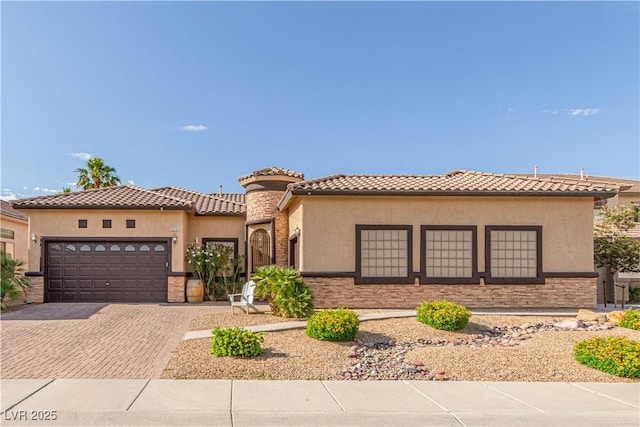 5576 Buena Martina Way, Las Vegas, NV 89141 - mediterranean / spanish-style house featuring stone siding, an attached garage, stucco siding, and decorative driveway