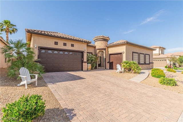5576 Buena Martina Way, Las Vegas, NV 89141 - mediterranean / spanish-style house featuring stucco siding, an attached garage, a tiled roof, and decorative driveway