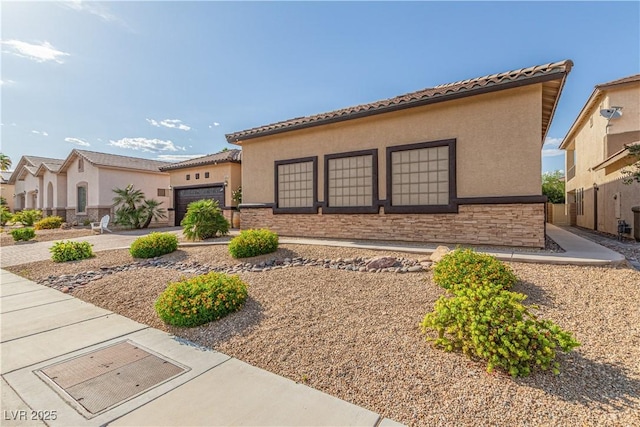5576 Buena Martina Way, Las Vegas, NV 89141 - mediterranean / spanish-style home with an attached garage, stucco siding, stone siding, and a tile roof