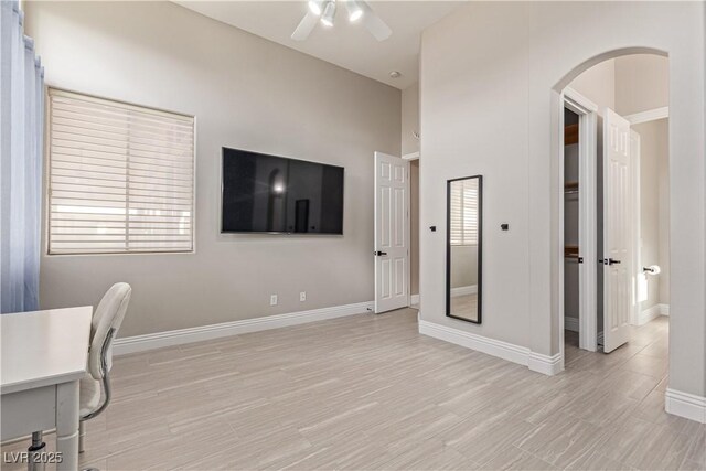 5576 Buena Martina Way, Las Vegas, NV 89141 - unfurnished office featuring arched walkways, ceiling fan, baseboards, and light wood-style flooring