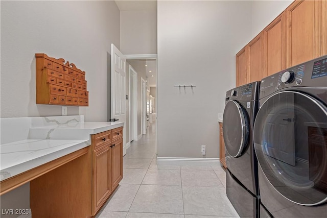 5576 Buena Martina Way, Las Vegas, NV 89141 - laundry room with cabinet space, washer and dryer, light tile patterned flooring, and a high ceiling