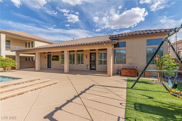 5576 Buena Martina Way, Las Vegas, NV 89141 - rear view of house featuring a patio area, a tiled roof, stucco siding, and a jacuzzi