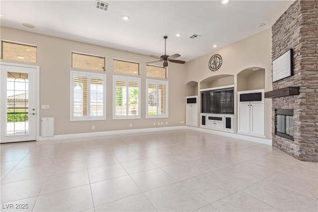 5576 Buena Martina Way, Las Vegas, NV 89141 - unfurnished living room featuring built in shelves, light tile patterned floors, plenty of natural light, and recessed lighting