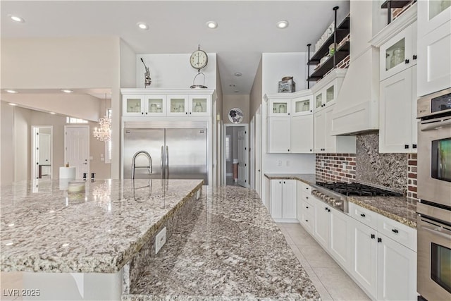 5576 Buena Martina Way, Las Vegas, NV 89141 - kitchen featuring appliances with stainless steel finishes, white cabinetry, a chandelier, light stone countertops, and recessed lighting