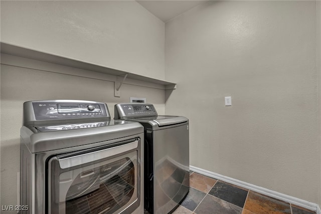 2449 Daks Loden Ct, Henderson, NV 89044 - laundry area featuring washer and dryer, baseboards, and dark stone finish flooring