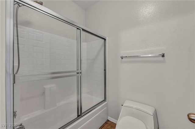 2449 Daks Loden Ct, Henderson, NV 89044 - bathroom with toilet, shower / bath combination with glass door, and baseboards