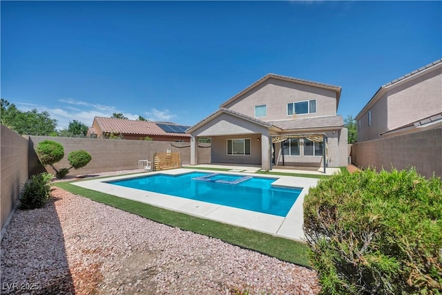 2449 Daks Loden Ct, Henderson, NV 89044 - rear view of house featuring stucco siding, a fenced backyard, a pool with connected hot tub, a patio, and a tiled roof