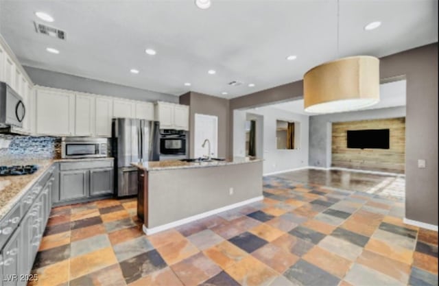 2449 Daks Loden Ct, Henderson, NV 89044 - kitchen with appliances with stainless steel finishes, open floor plan, recessed lighting, a center island with sink, and a sink