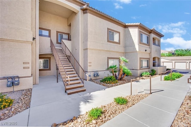8725 W Flamingo Rd Unit 110, Las Vegas, NV 89147 - view of home's exterior with stucco siding and stairs