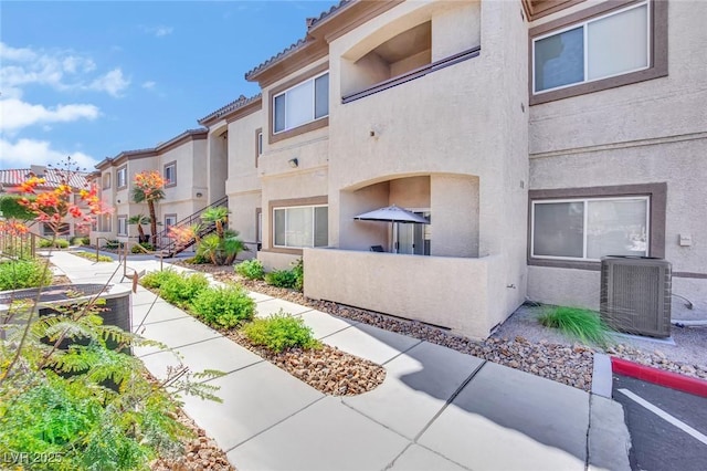 8725 W Flamingo Rd Unit 110, Las Vegas, NV 89147 - view of building exterior with cooling unit and a residential view