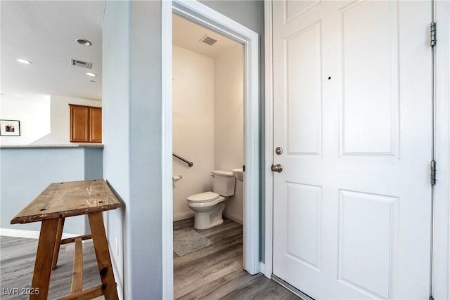 6121 Mission Gorge Ct, Las Vegas, NV 89130 - bathroom featuring toilet, wood finished floors, baseboards, and recessed lighting