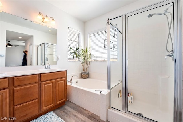 6121 Mission Gorge Ct, Las Vegas, NV 89130 - full bath featuring a stall shower, wood finished floors, vanity, a ceiling fan, and a garden tub
