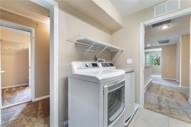 11238 Meadow Cove St, Las Vegas, NV 89179 - laundry area with light colored carpet, washer and dryer, and baseboards