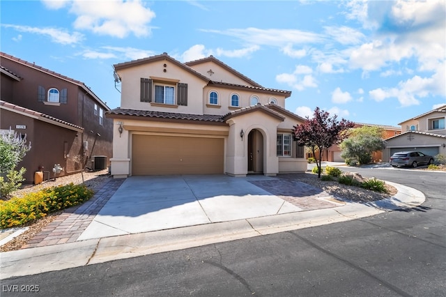 11238 Meadow Cove St, Las Vegas, NV 89179 - mediterranean / spanish house with stucco siding, central AC unit, an attached garage, driveway, and a tiled roof