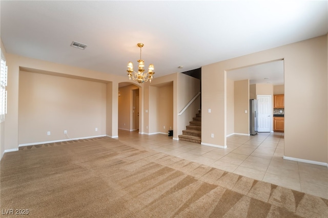 11238 Meadow Cove St, Las Vegas, NV 89179 - unfurnished room with arched walkways, light tile patterned floors, stairs, baseboards, and light carpet