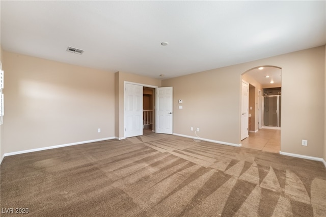 11238 Meadow Cove St, Las Vegas, NV 89179 - empty room with arched walkways, carpet floors, and baseboards