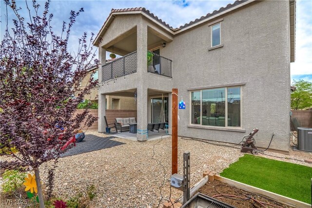 10031 Fletcher Peak Ave, Las Vegas, NV 89178 - back of house featuring a balcony, stucco siding, outdoor lounge area, a patio, and central air condition unit