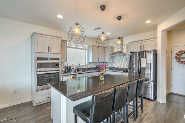 10031 Fletcher Peak Ave, Las Vegas, NV 89178 - kitchen featuring stainless steel appliances, gray cabinets, dark wood-style flooring, tasteful backsplash, and recessed lighting