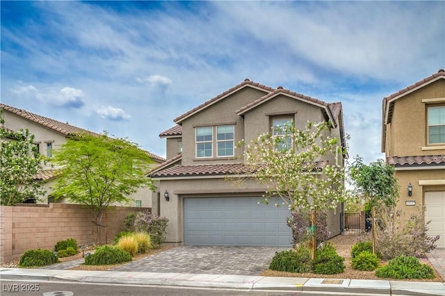 10031 Fletcher Peak Ave, Las Vegas, NV 89178 - view of front of home featuring a tile roof, stucco siding, an attached garage, and driveway