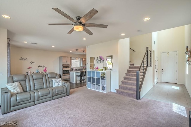 10031 Fletcher Peak Ave, Las Vegas, NV 89178 - living area featuring light colored carpet, ceiling fan, recessed lighting, and stairway