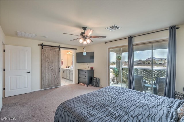 10031 Fletcher Peak Ave, Las Vegas, NV 89178 - bedroom with access to exterior, a barn door, carpet, and ensuite bath