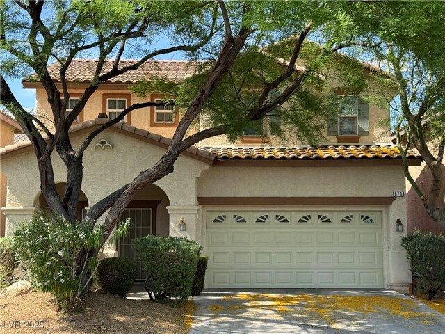 8708 Gateway Glen Dr, Las Vegas, NV 89178 - mediterranean / spanish-style home featuring stucco siding, a tile roof, an attached garage, and driveway