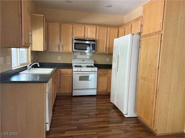 8708 Gateway Glen Dr, Las Vegas, NV 89178 - kitchen with white appliances, a sink, dark countertops, dark wood-style floors, and light brown cabinetry