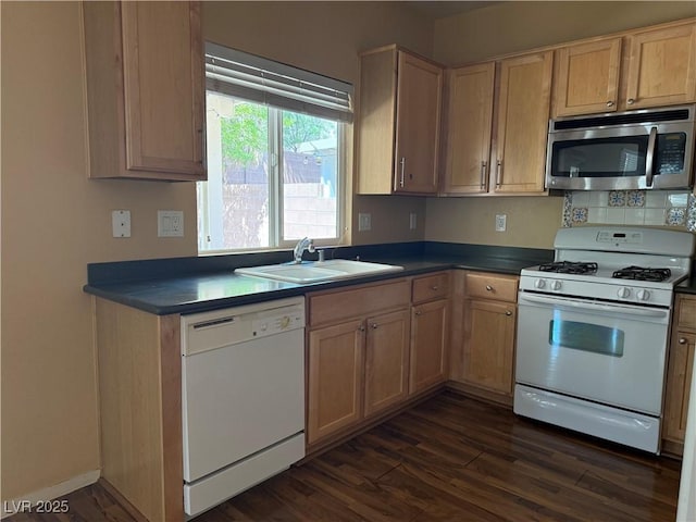 8708 Gateway Glen Dr, Las Vegas, NV 89178 - kitchen with white appliances, a sink, dark wood-style floors, dark countertops, and decorative backsplash