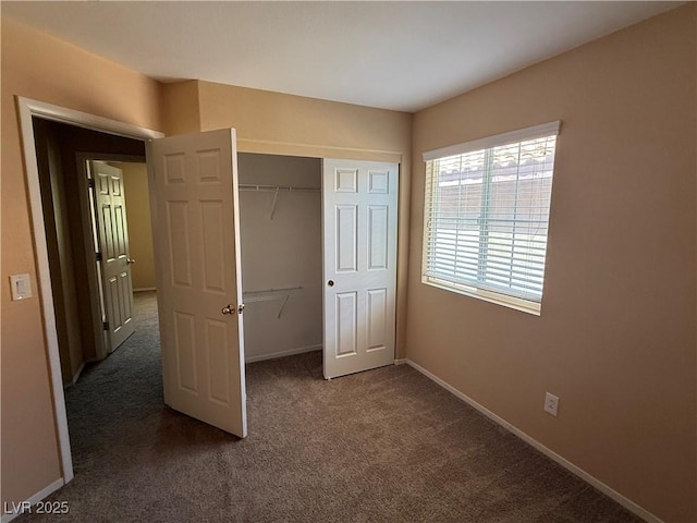 8708 Gateway Glen Dr, Las Vegas, NV 89178 - unfurnished bedroom featuring dark carpet, baseboards, and a closet