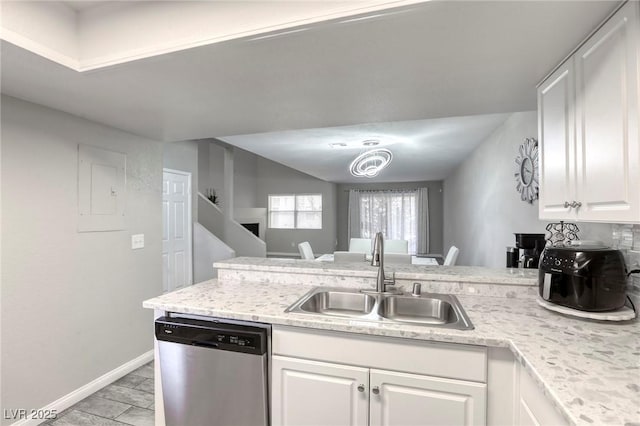 6250 W Flamingo Rd Unit 43, Las Vegas, NV 89103 - kitchen featuring dishwasher, a sink, a peninsula, white cabinets, and baseboards