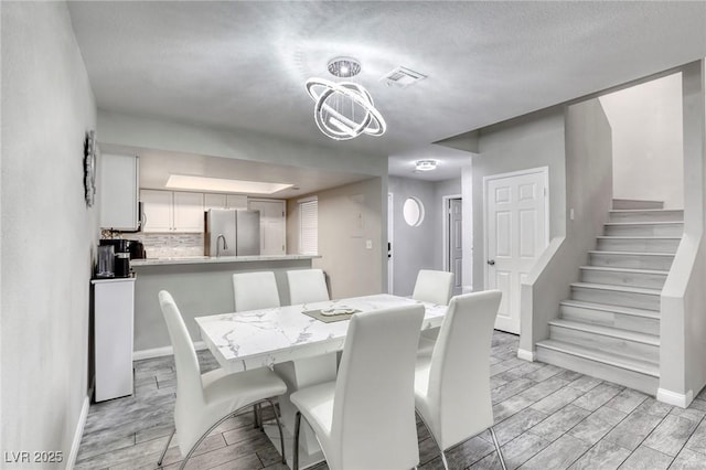 6250 W Flamingo Rd Unit 43, Las Vegas, NV 89103 - dining area featuring wood finish floors, stairway, and baseboards