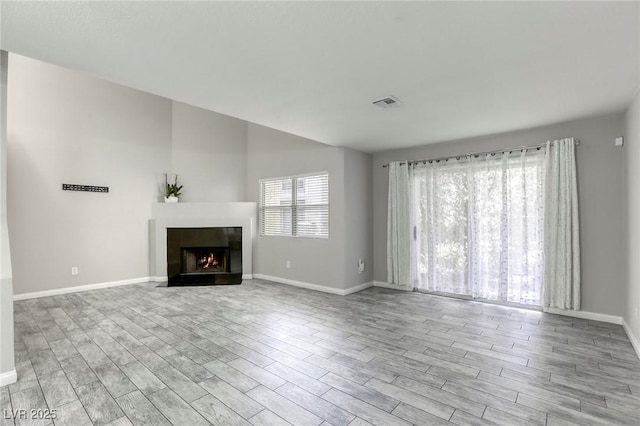6250 W Flamingo Rd Unit 43, Las Vegas, NV 89103 - unfurnished living room with wood finished floors, baseboards, and a fireplace with flush hearth